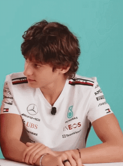 Man In Mercedes Shirt With Hands Folded At Desk GIF