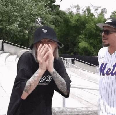 Man In Mets Jersey And Woman Covering Face GIF
