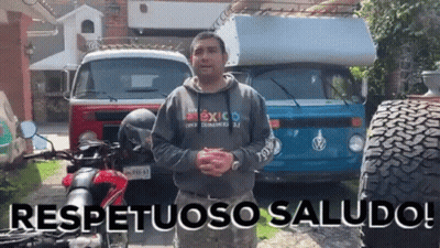 Man In Mexico Sweatshirt In Front Of Vehicles GIF