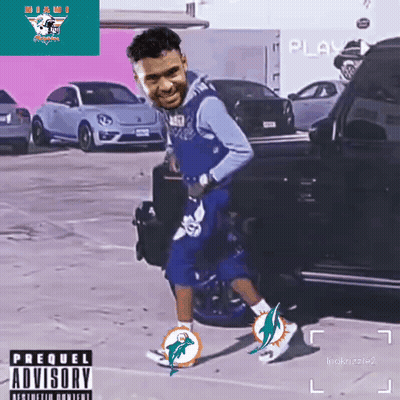 Man In Miami Dolphins Jersey Standing In Parking Lot GIF