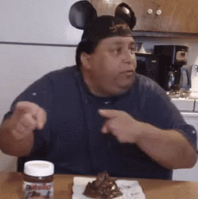 Man In Mickey Mouse Ears Sitting With Nutella GIF