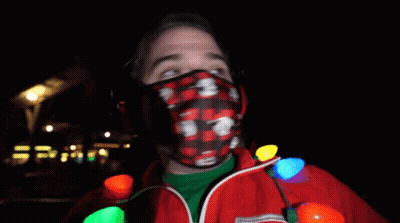Man In Mickey Mouse Mask Holding Christmas Lights GIF