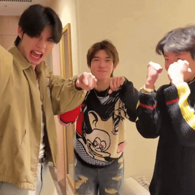 Man In Mickey Mouse Sweater Pointing GIF