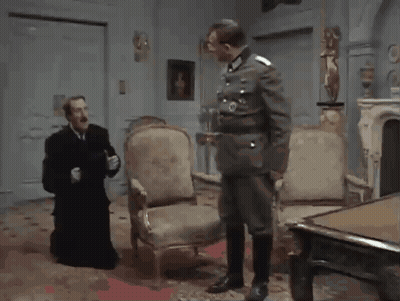 Man In Military Talking To Man In Black Robe GIF