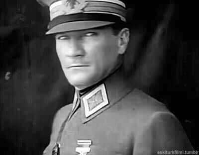 Man In Military Uniform And Hat Looking At Camera GIF