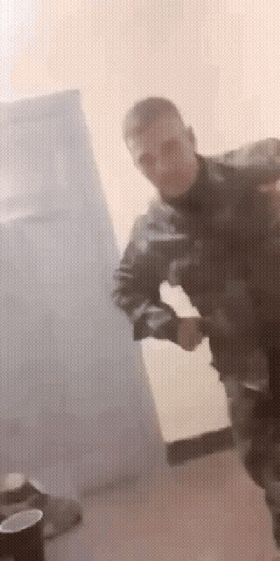 Man In Military Uniform Dancing With Gun GIF