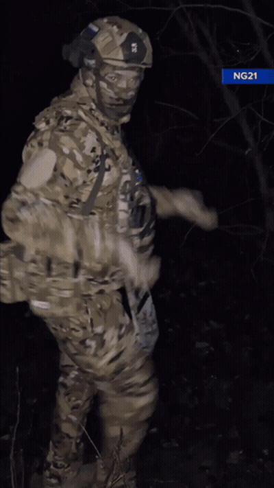 Man In Military Uniform Giving Thumbs Up In Dark GIF