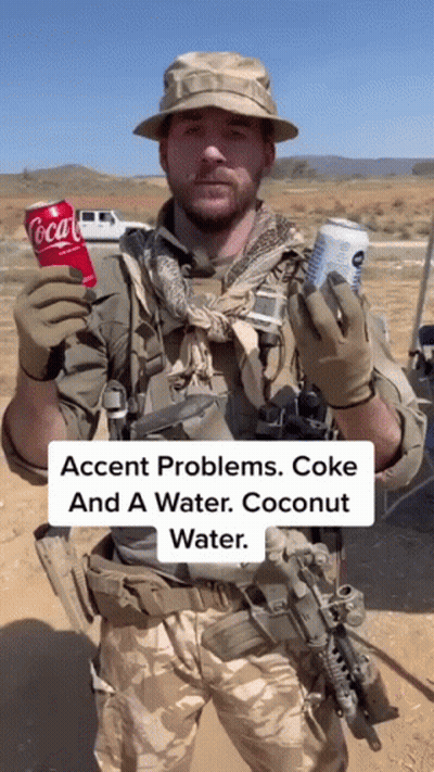 Man In Military Uniform Holding Coca Cola And Coconut Water GIF