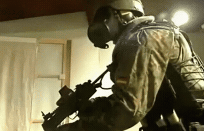 Man In Military Uniform Holding Gun GIF