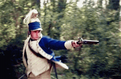 Man In Military Uniform Holding Gun In Woods GIF