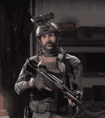 Man In Military Uniform Holding Gun With British Flag Patch GIF