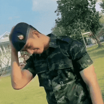 Man In Military Uniform Holding Head GIF