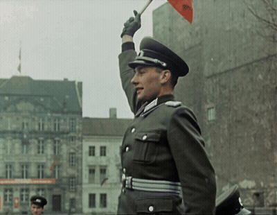 Man In Military Uniform Holding Red Flag With RSC GIF