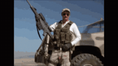 Man in Military Uniform Holding Rifle