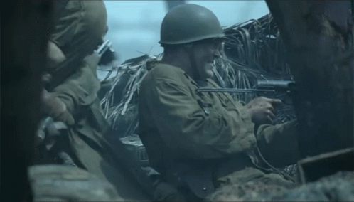 Man In Military Uniform Holding Rifle GIF