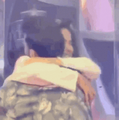 Man In Military Uniform Hugging Woman In Plane GIF