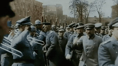 Man In Military Uniform Looking At Camera In Snow GIF