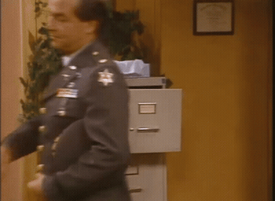 Man In Military Uniform Looking At Filing Cabinet GIF