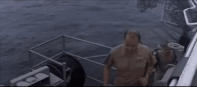 Man In Military Uniform On Boat Looking At Camera GIF