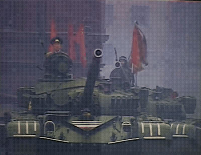 Man In Military Uniform On Tank Holding Gun GIF