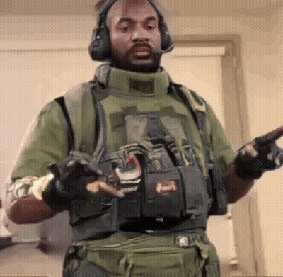Man in Military Uniform Pointing at Camera