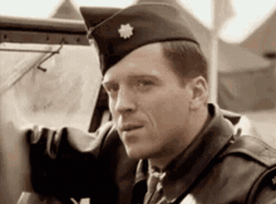 Man In Military Uniform Sitting In Car Looking Out Window GIF