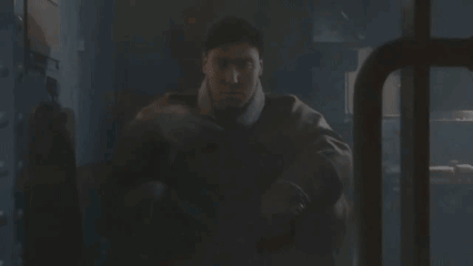 Man In Military Uniform Sitting In Dark Room GIF