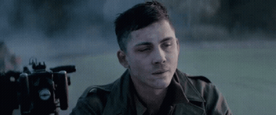 Man In Military Uniform Sitting In Front Of Camera GIF