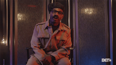 Man In Military Uniform Sitting With Bet Logo GIF