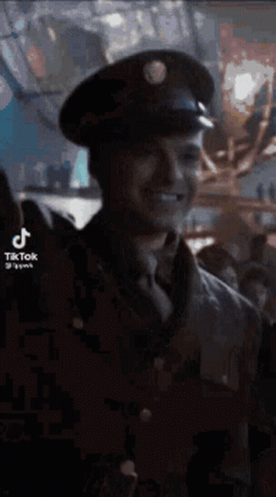 Man In Military Uniform Smiling In Crowd GIF