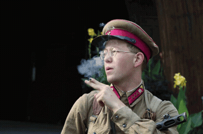 Man In Military Uniform Smoking Cigarette And Pointing GIF