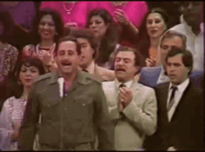 Man In Military Uniform Standing Before Crowd In Suits GIF