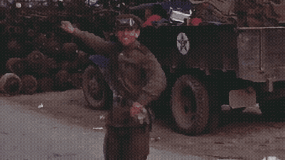 Man In Military Uniform Standing By Truck With Star GIF