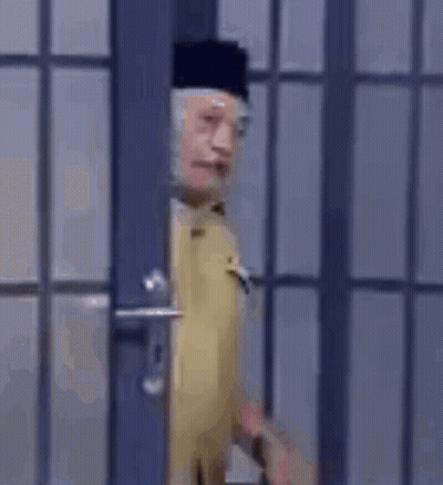 Man In Military Uniform Standing In Front Of Door GIF