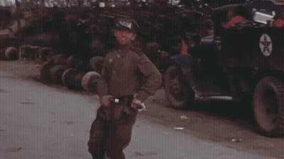 Man in Military Uniform Standing in Front of Star Truck