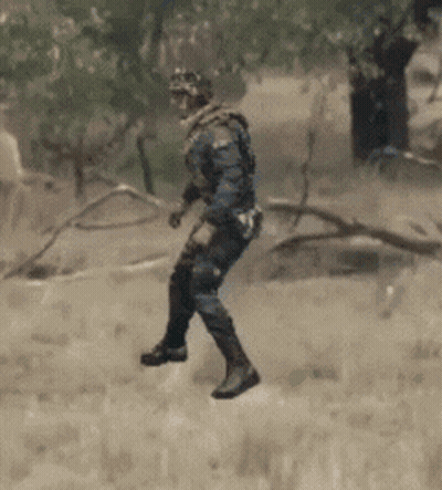 Man in Military Uniform Walking in Grass