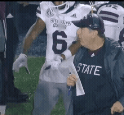 Man In Mississippi Jersey Beside Football Player GIF