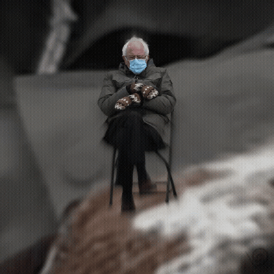 Man In Mittens And Face Mask Sitting In Chair GIF