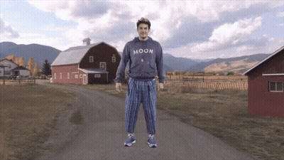 Man In Moon Sweatshirt In Front Of Barn GIF
