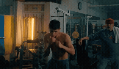 Man In Moscow Sweatshirt Next To Shirtless Man GIF