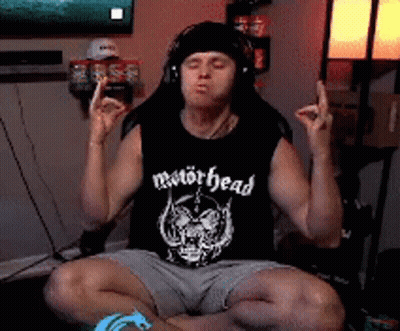 Man In Motörhead Tank Top Eyes Closed In Lotus Position GIF