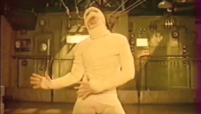 Man In Mummy Costume Standing In Room GIF