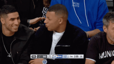 Man In Munich Shirt Sitting In Crowd GIF