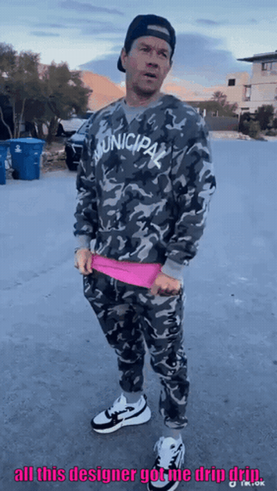Man In Municipal Sweatshirt Standing On Street GIF