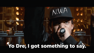 Man In N.W.A Hat Holding Microphone Saying Yo Dre GIF