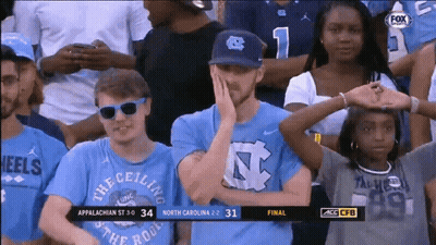Man In NASA Jacket Looking Through Glass GIF