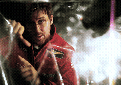 Man In NASA Jacket Looking Through Glass GIF