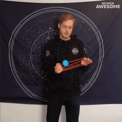 Man In NASA Shirt Spinning Yo-Yo In Front Of Awesome Tapestry GIF