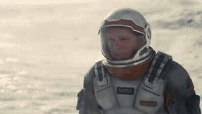 Man In NASA Spacesuit In Desert GIF