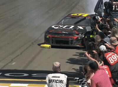 Man In Nascar Shirt Watching Race Car GIF